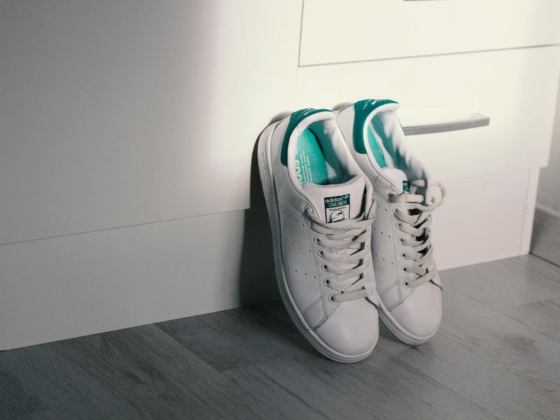 Athletic shoes and a timer on a clean floor.